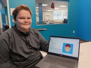 Student shows his work on computer screen.