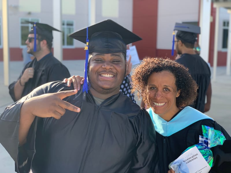 Gilmore poses with graduate at ceremony