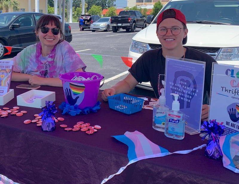 Community partners sit at a vendor tent
