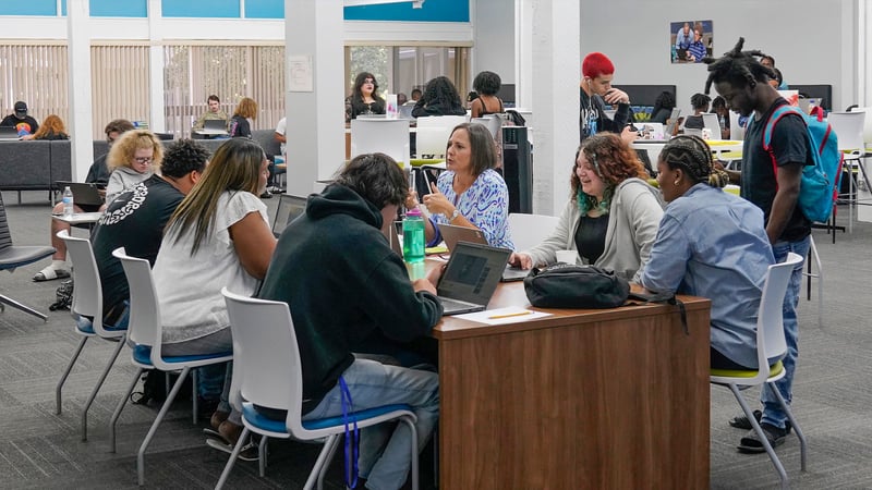 Bustling scene inside Acceleration Academies, flexible, open learning space