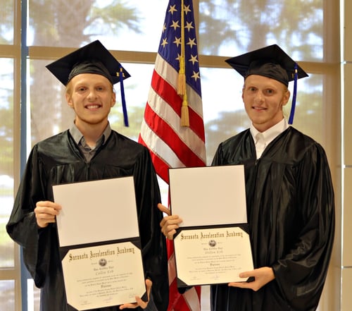 Two brothers in cap and gown showcase their new diplmoas