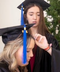 Ava adjusting graduation cap.
